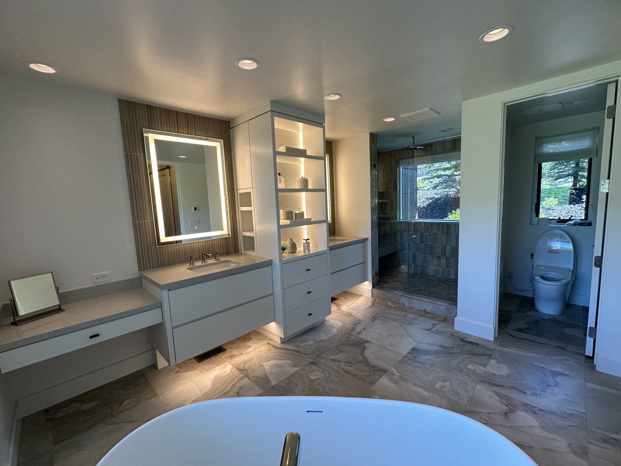 A Bathroom With a Large Mirror and a Jacuzzi