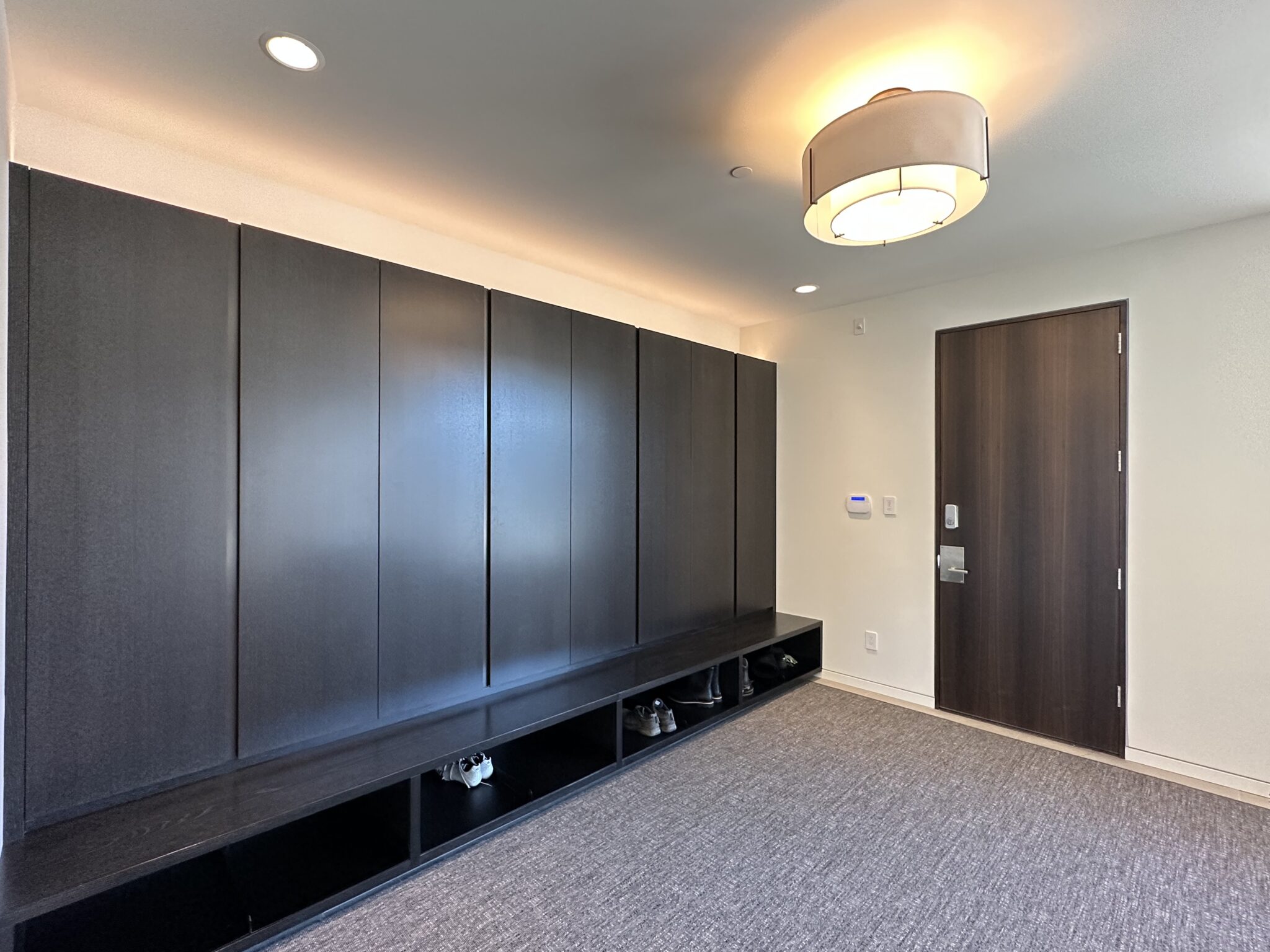 A Room With Dark Cabinets and Doors