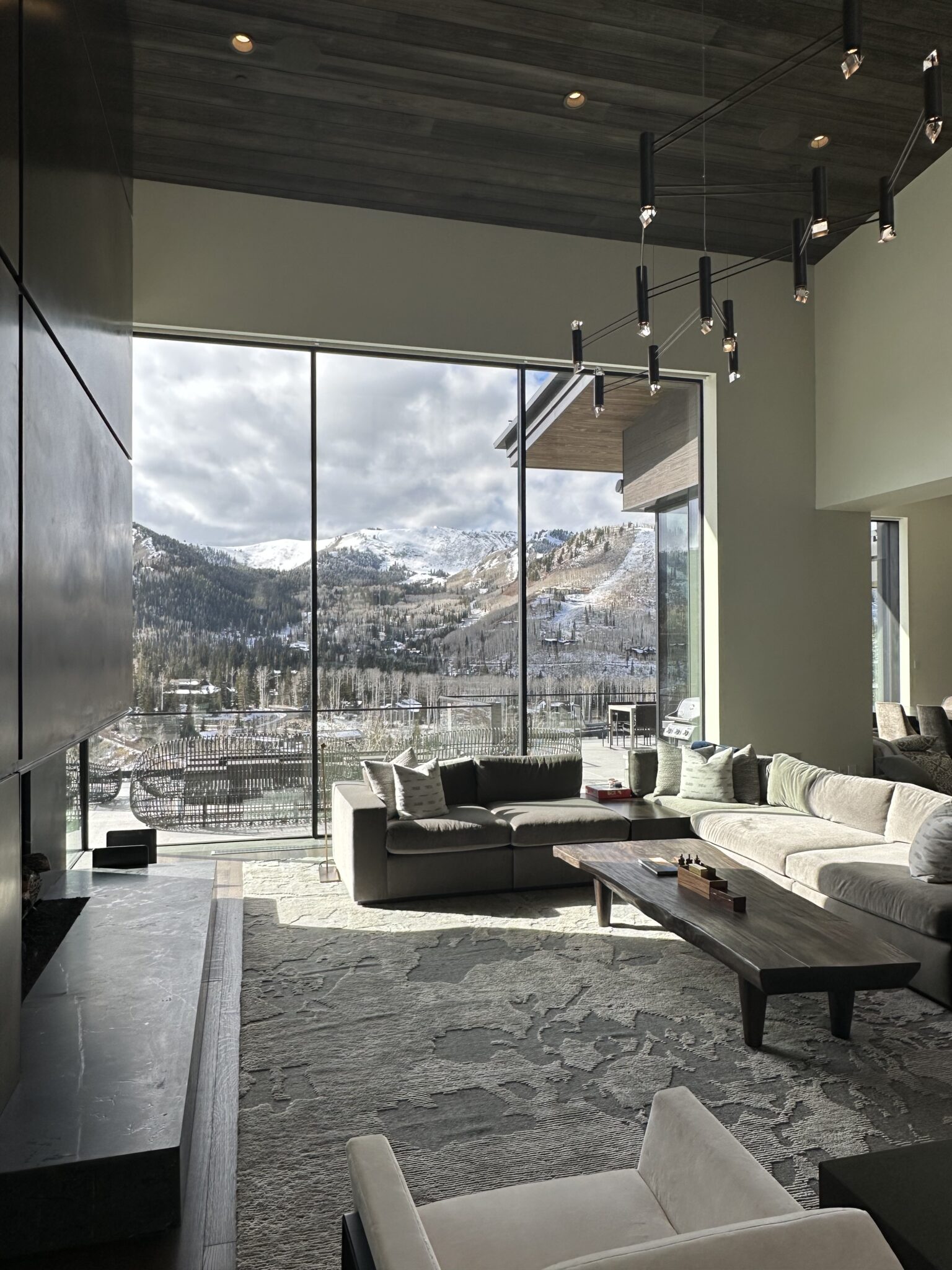 A Living Room With Large Windows and a Couch and a Coffee Table