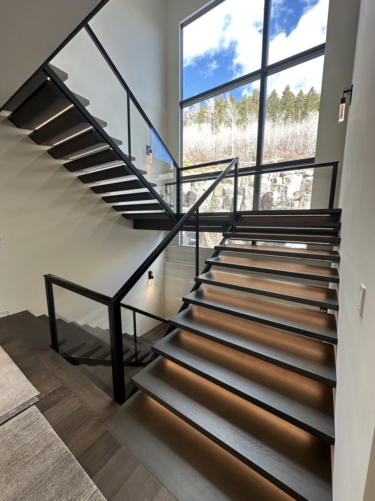 A Staircase With Glass Railings and a Window