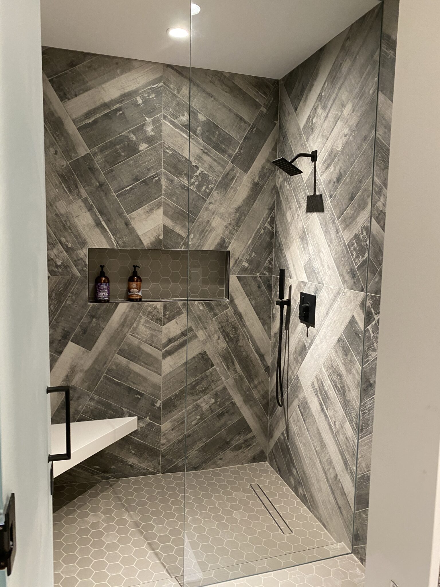 A Shower With a Shower Head and a Shelf
