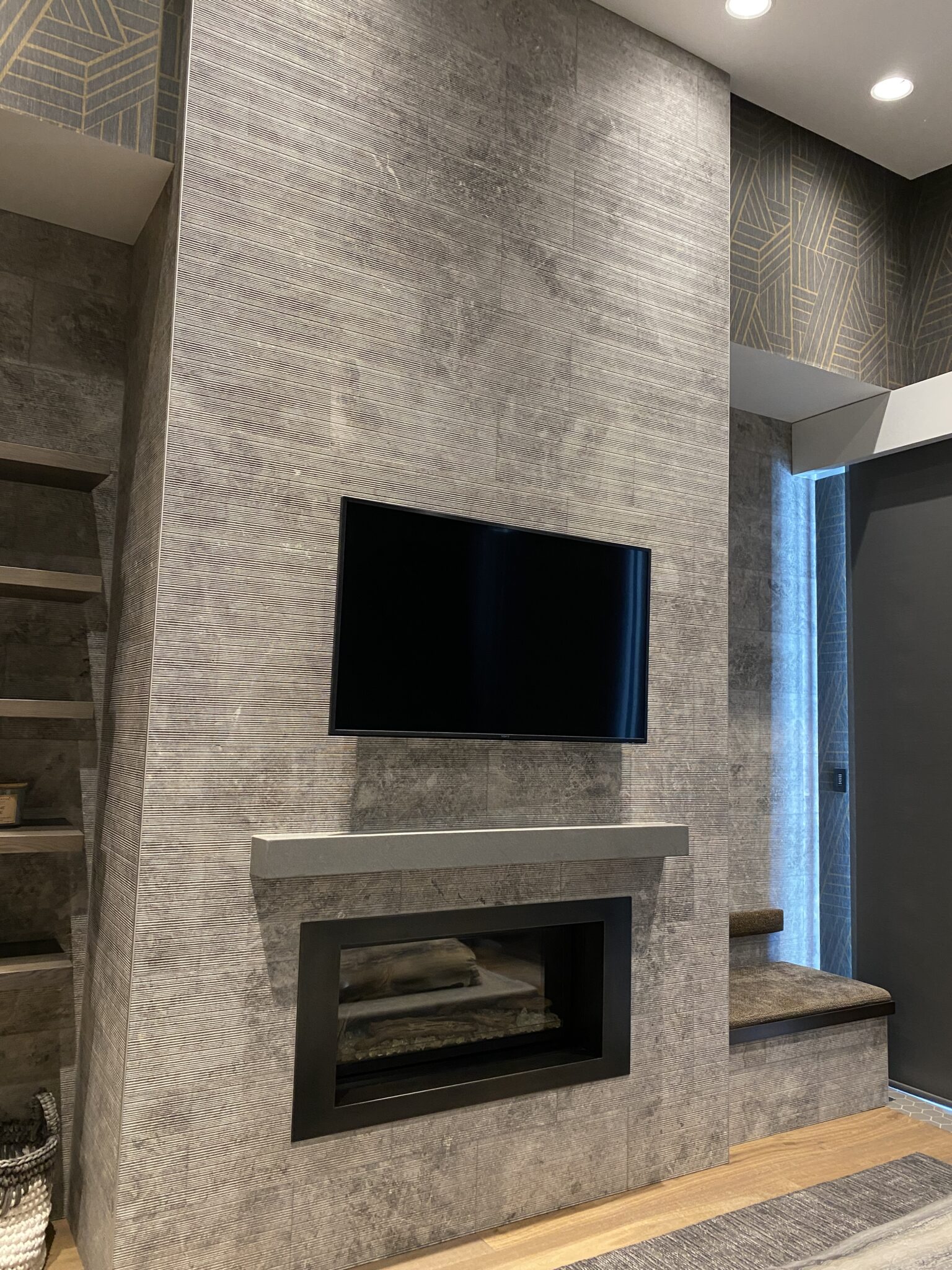 A Tv on a Wall Above the Fireplace